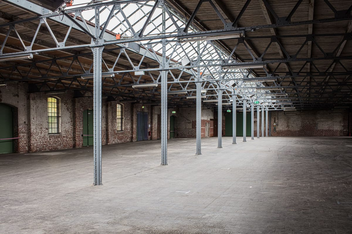 Light coming through the skylight of a dark, empty warehouse