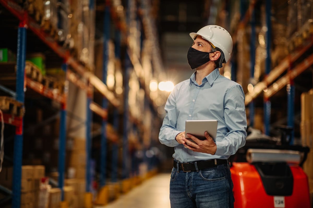 An inventory manager inspecting inventory and verifying quantities in a warehouse