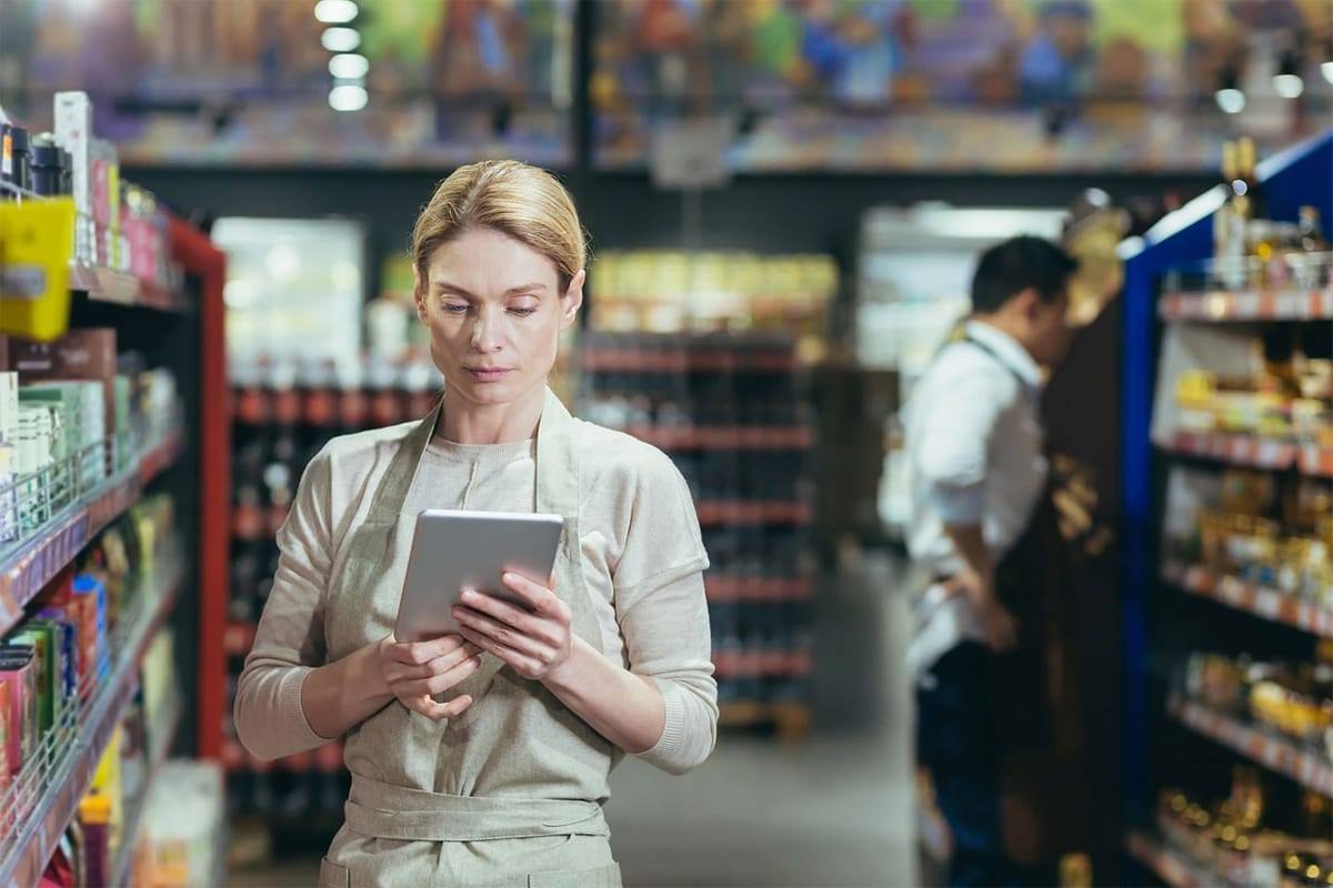 A manager at a supermarket checking the inventory.