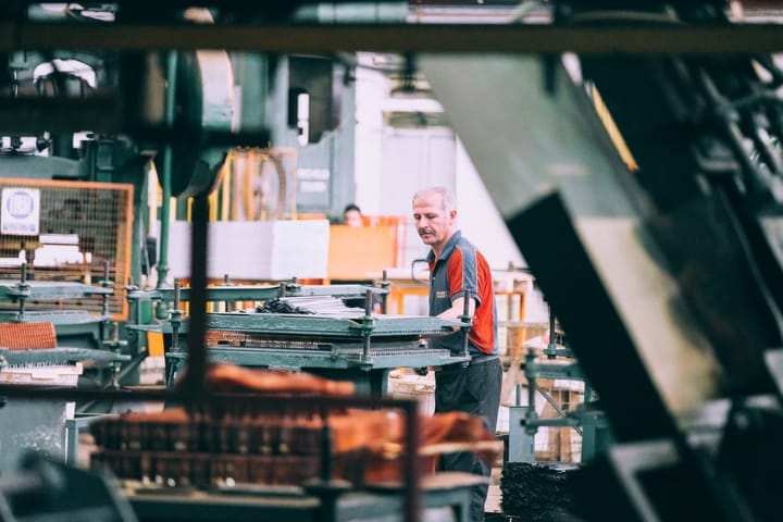 Worker processing raw materials in a plant.