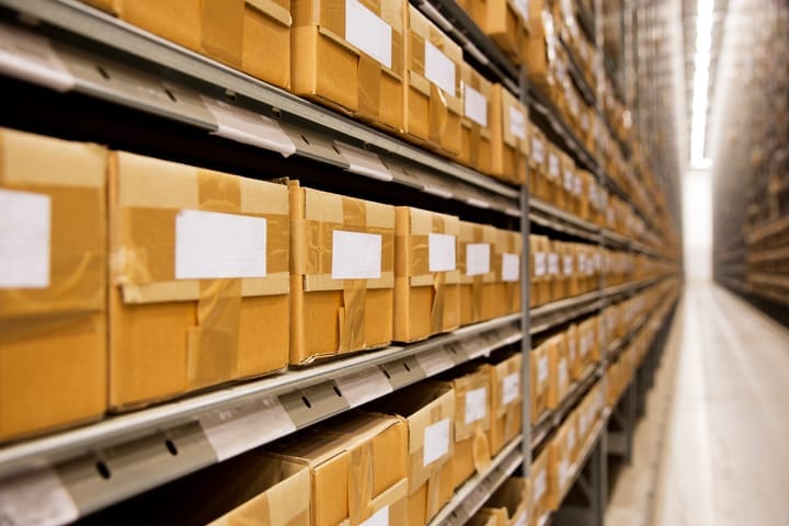 Large group of cardboard boxes in a warehouse.