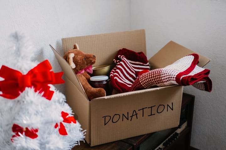 A donation box filled with toys, clothes, and goods, ready for the season of giving