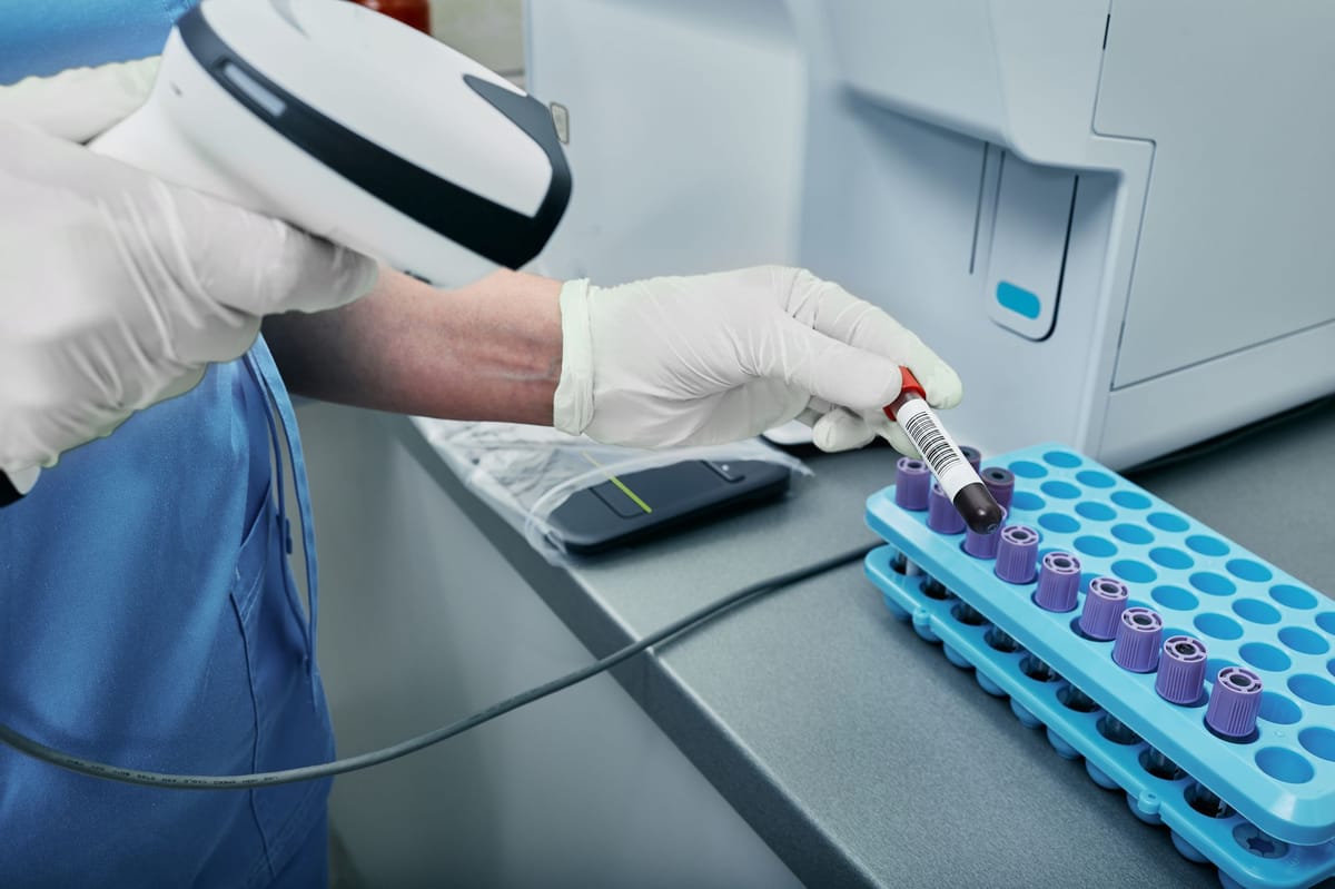 Doctors checking blood samples with barcodes.