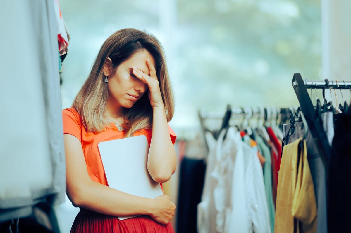 Sad businessowner having issues with clothing inventory