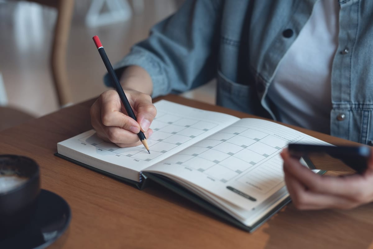 A woman checking mobile phone calendar for planning and scheduling