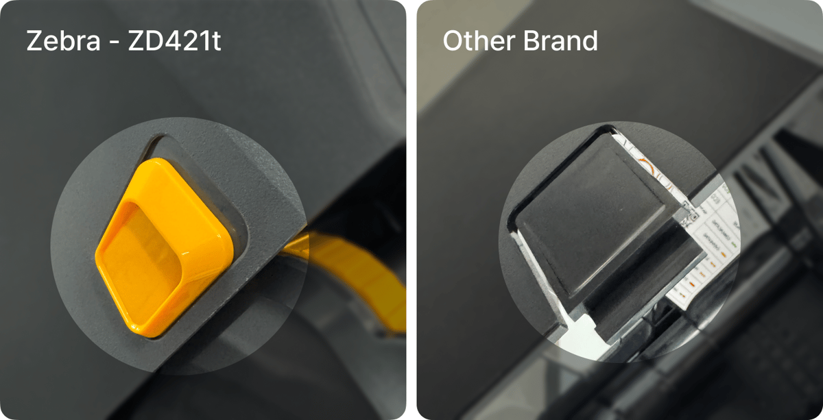 Close-up comparison of ribbon cartridge designs: Zebra ZD421t with a yellow diamond-shaped cartridge slot versus another brand with a narrower, more cramped cartridge mechanism
