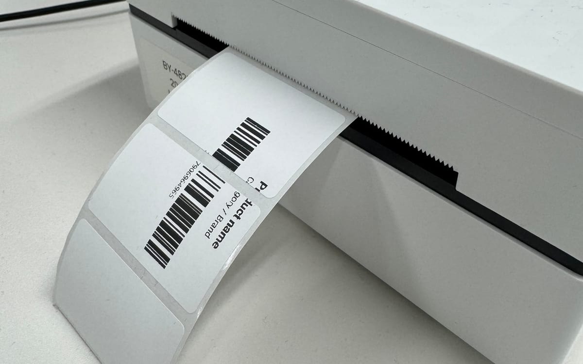 A thermal label printer with a freshly printed shipping label rotated sideways